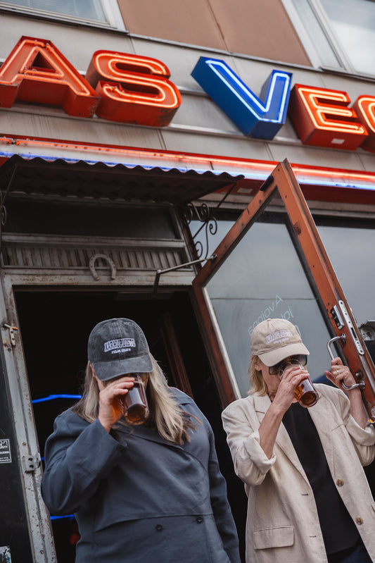 Elina Knihtilä and Pirjo Lonka in Kallio, wearing FC Karhupuisto caps by Karhupuisto Film Festival. Picture taken by Timea Slavic.