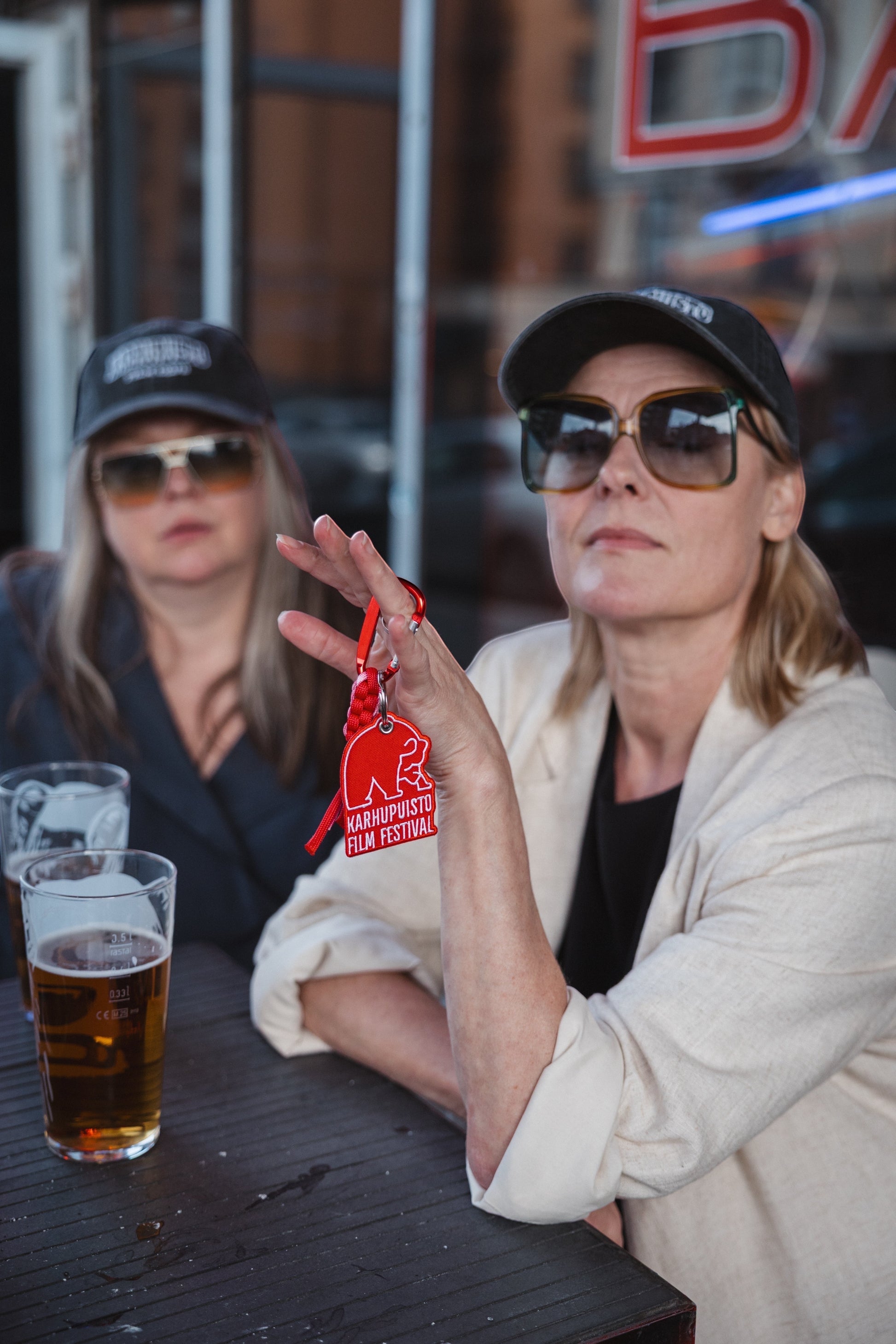 Elina Knihtilä and Pirjo Lonka in Kallio, wearing FC Karhupuisto caps by Karhupuisto Film Festival. Picture taken by Timea Slavic.