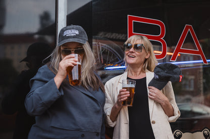 Elina Knihtilä and Pirjo Lonka in Kallio, wearing FC Karhupuisto caps by Karhupuisto Film Festival. Picture taken by Timea Slavic.