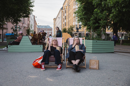 Elina Knihtilä and Pirjo Lonka in Kallio, wearing FC Karhupuisto caps by Karhupuisto Film Festival. Picture taken by Timea Slavic.