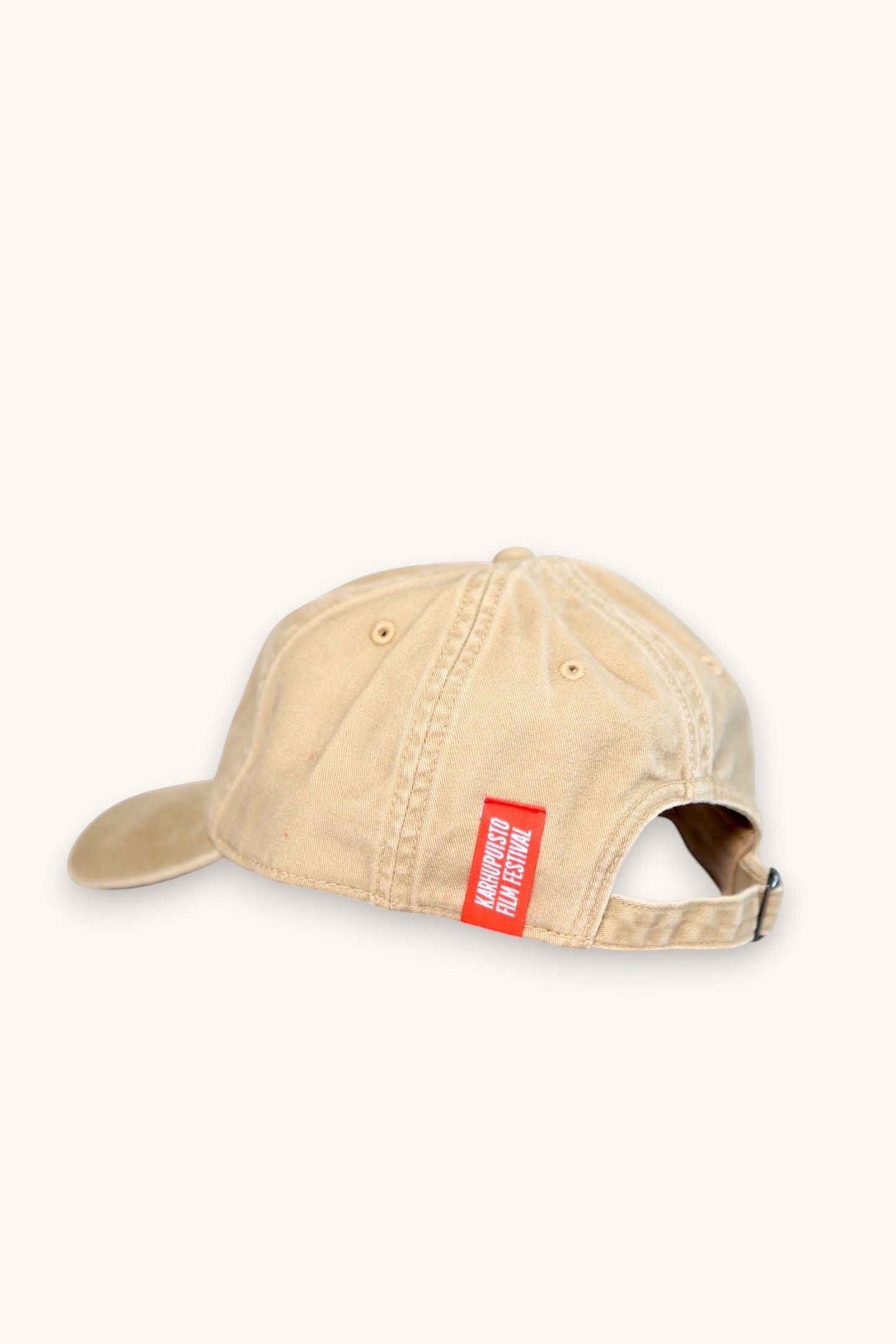 Karhupuisto Film Festival beige cotton baseball cap with red branded back tab, side view
