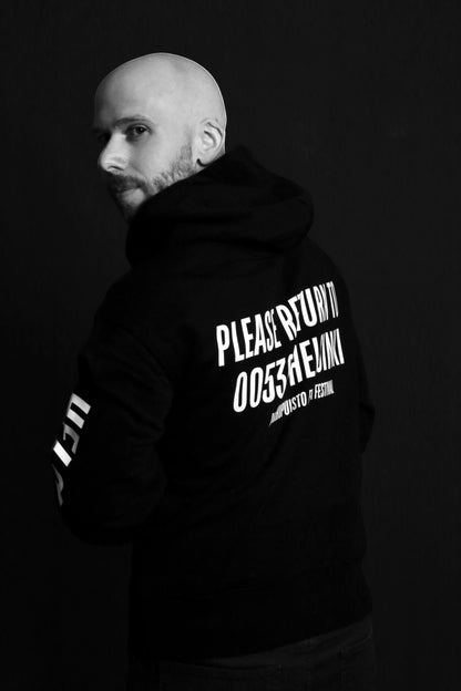 Karhupuisto Film Festival black unisex hoodie with white back print worn by a man against a dark background