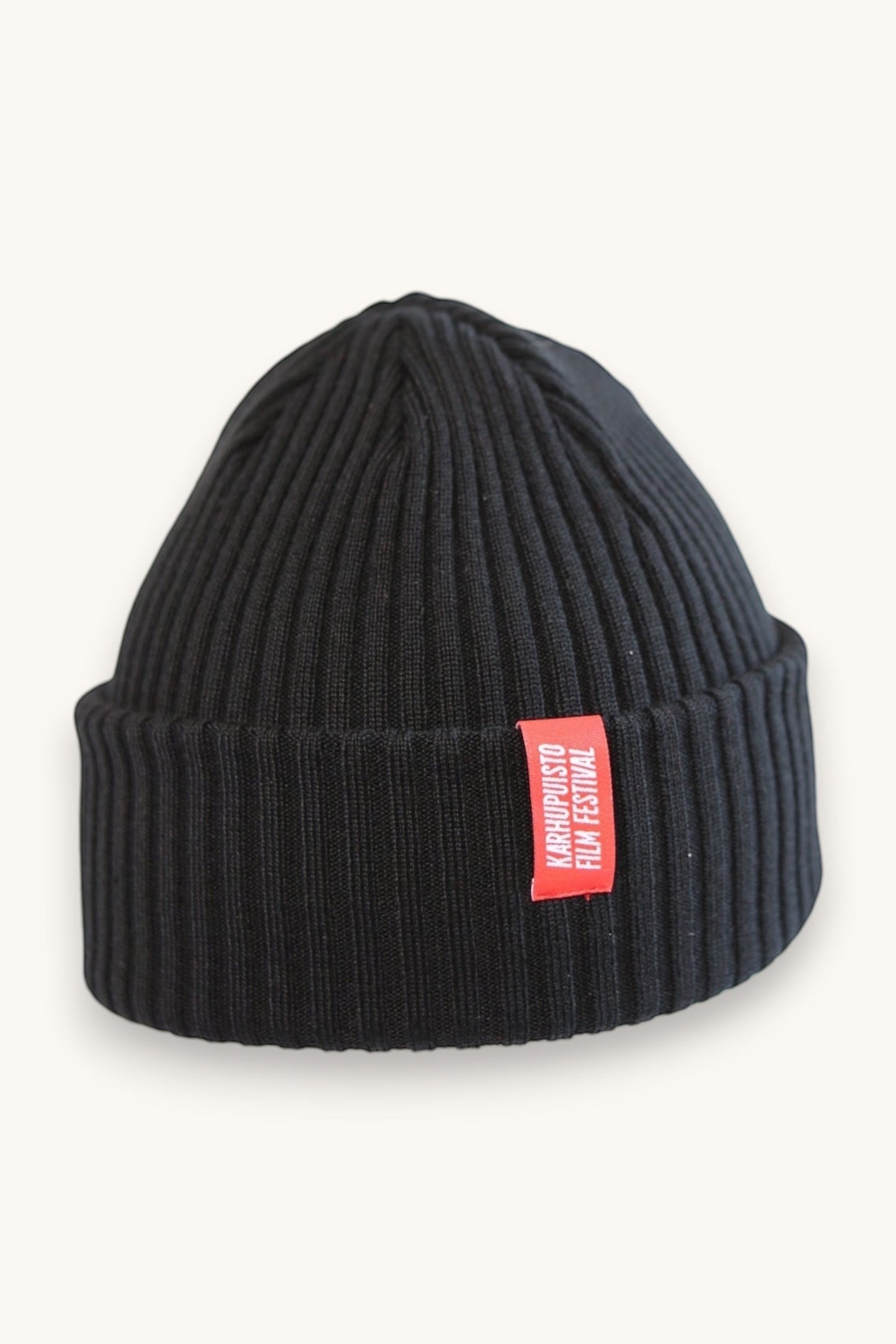 Karhupuisto Film Festival black ribbed knit beanie with a folded cuff and a vibrant red branded woven label.
