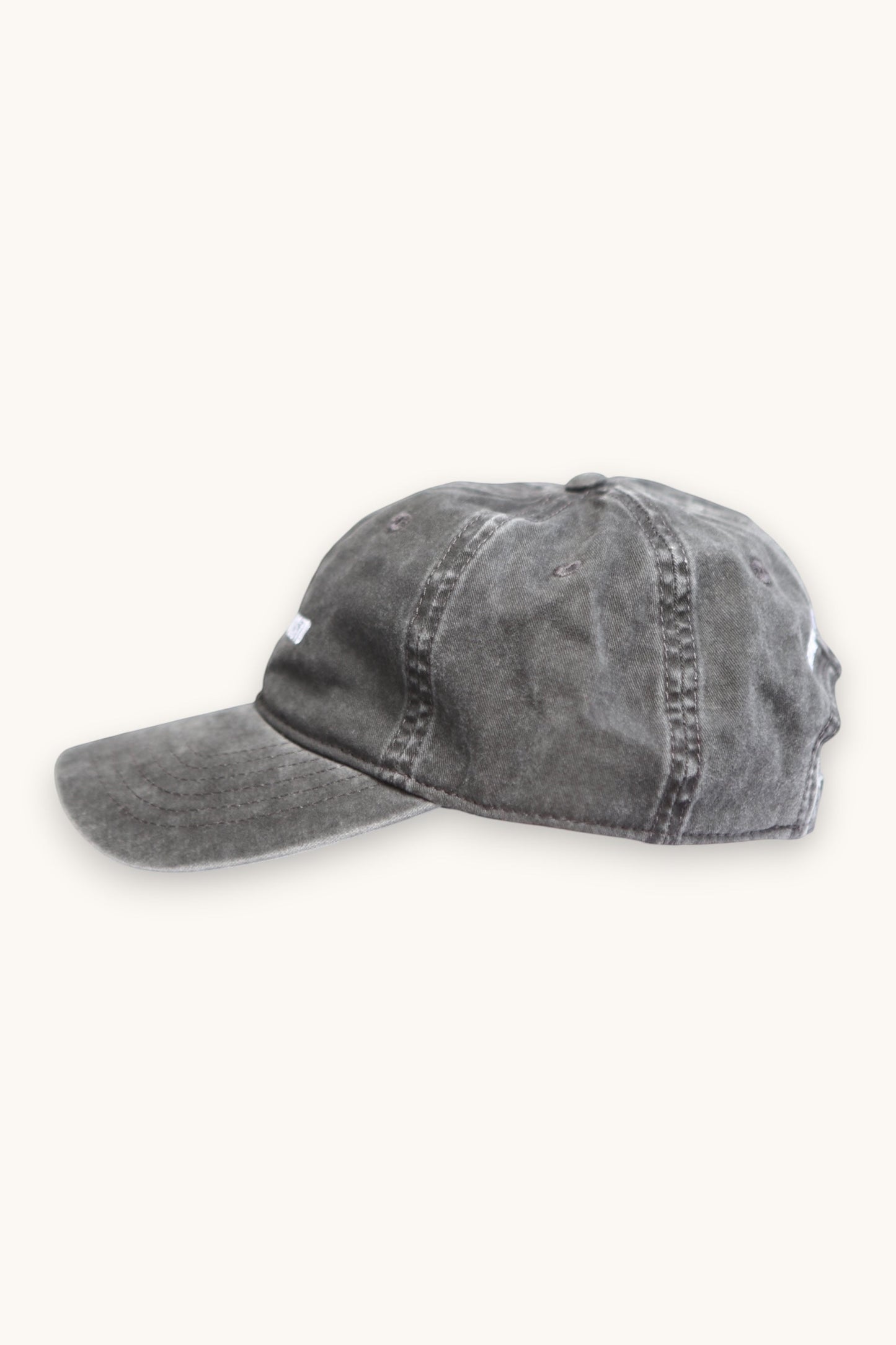 Karhupuisto Film Festival black vintage-washed cotton skate cap with adjustable buckle strap, side profile view.