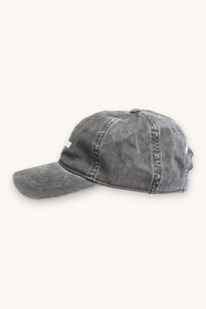 Karhupuisto Film Festival black vintage-washed cotton skate cap with adjustable buckle strap, side profile view.