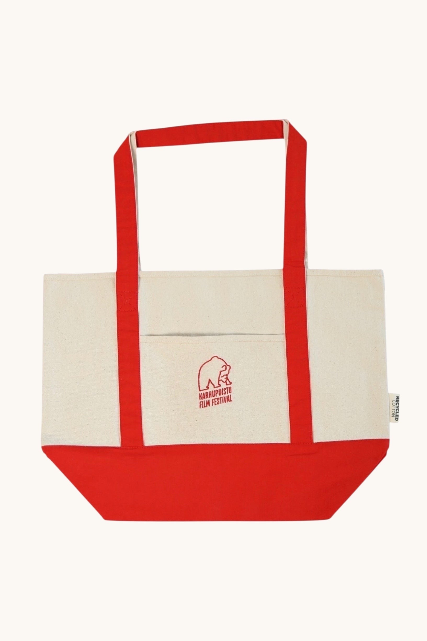 Karhupuisto Film Festival recycled cotton canvas tote bag in cream with red handles, base, and bear logo pocket.