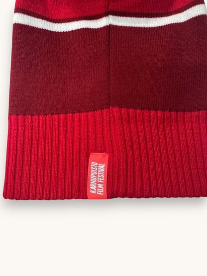 Karhupuisto Film Festival red and burgundy knit beanie with white stripe and woven brand label on the ribbed cuff