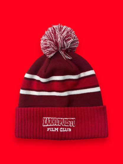 Karhupuisto Film Festival red and burgundy knit pom-pom beanie with white stripes and embroidered logo on ribbed cuff