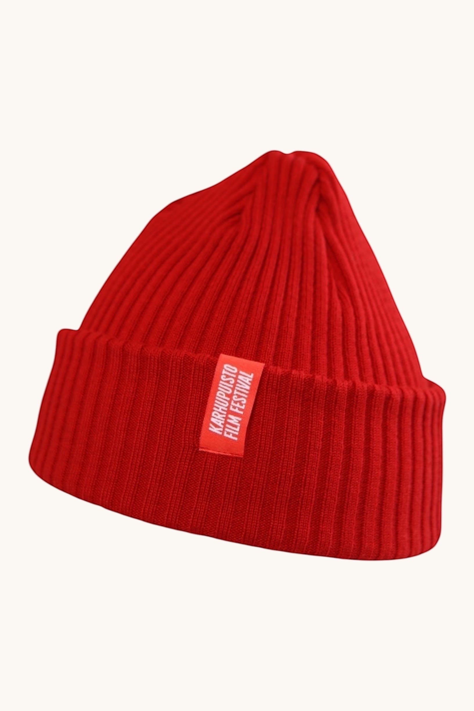 Karhupuisto Film Festival vibrant red ribbed knit beanie with a branded woven label on the cuff.