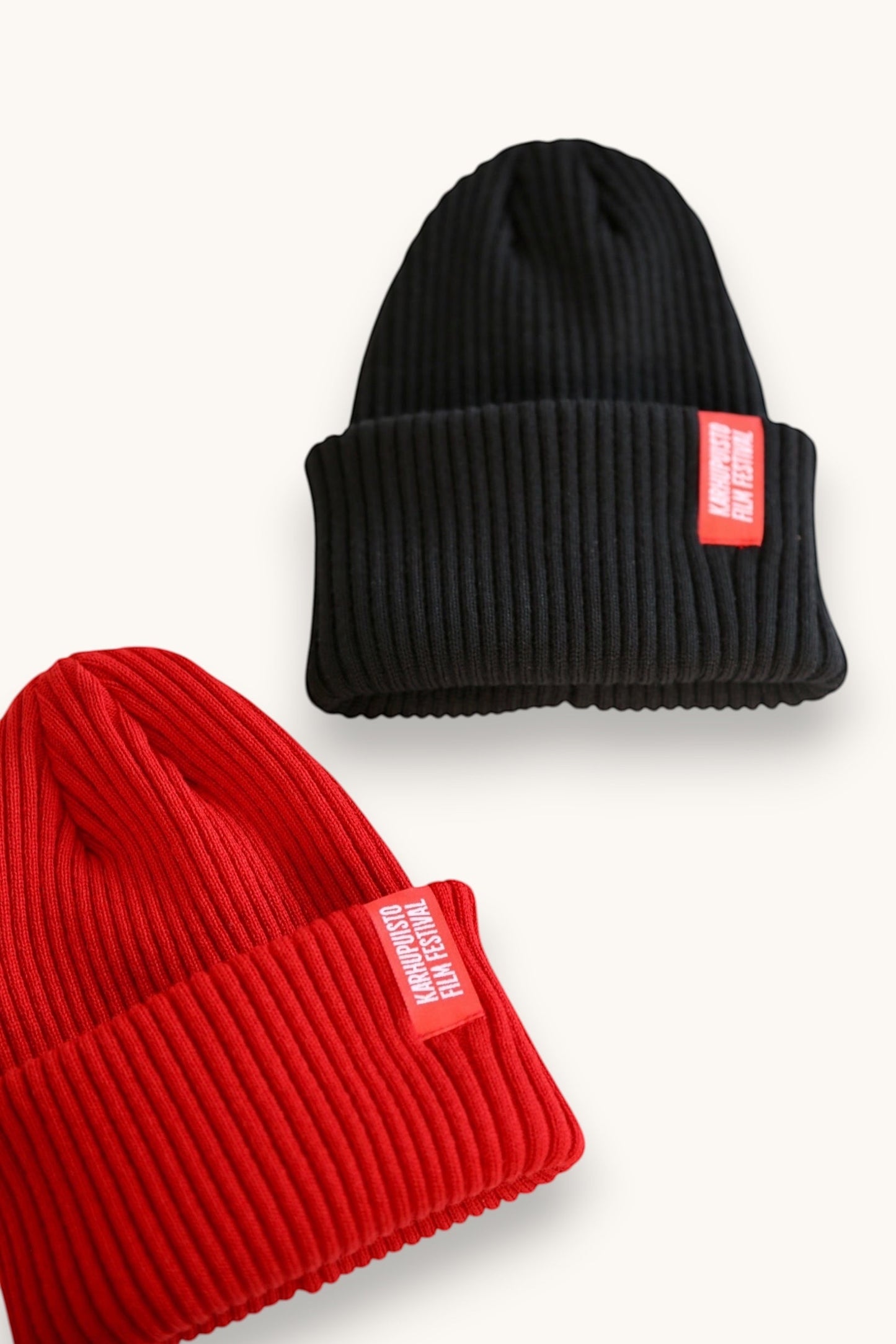 Karhupuisto Film Festival black and red ribbed knit beanies with folded cuffs and branded woven labels