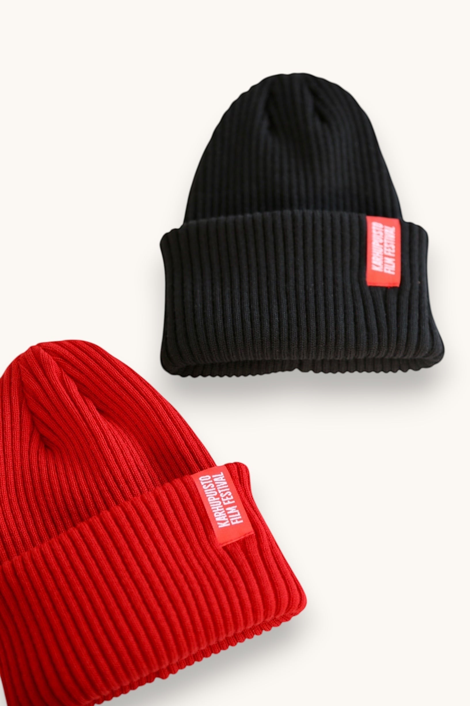 Karhupuisto Film Festival black and red ribbed knit beanies with folded cuffs and branded woven labels